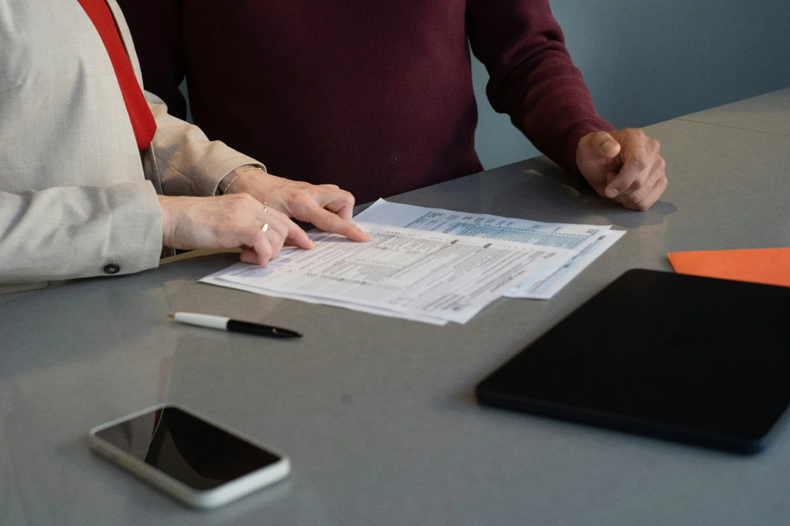 Two people reviewing documents at a desk
